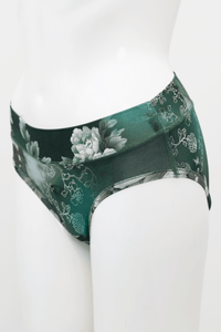 Side view of green bamboo hipster underwear with floral pattern on mannequin