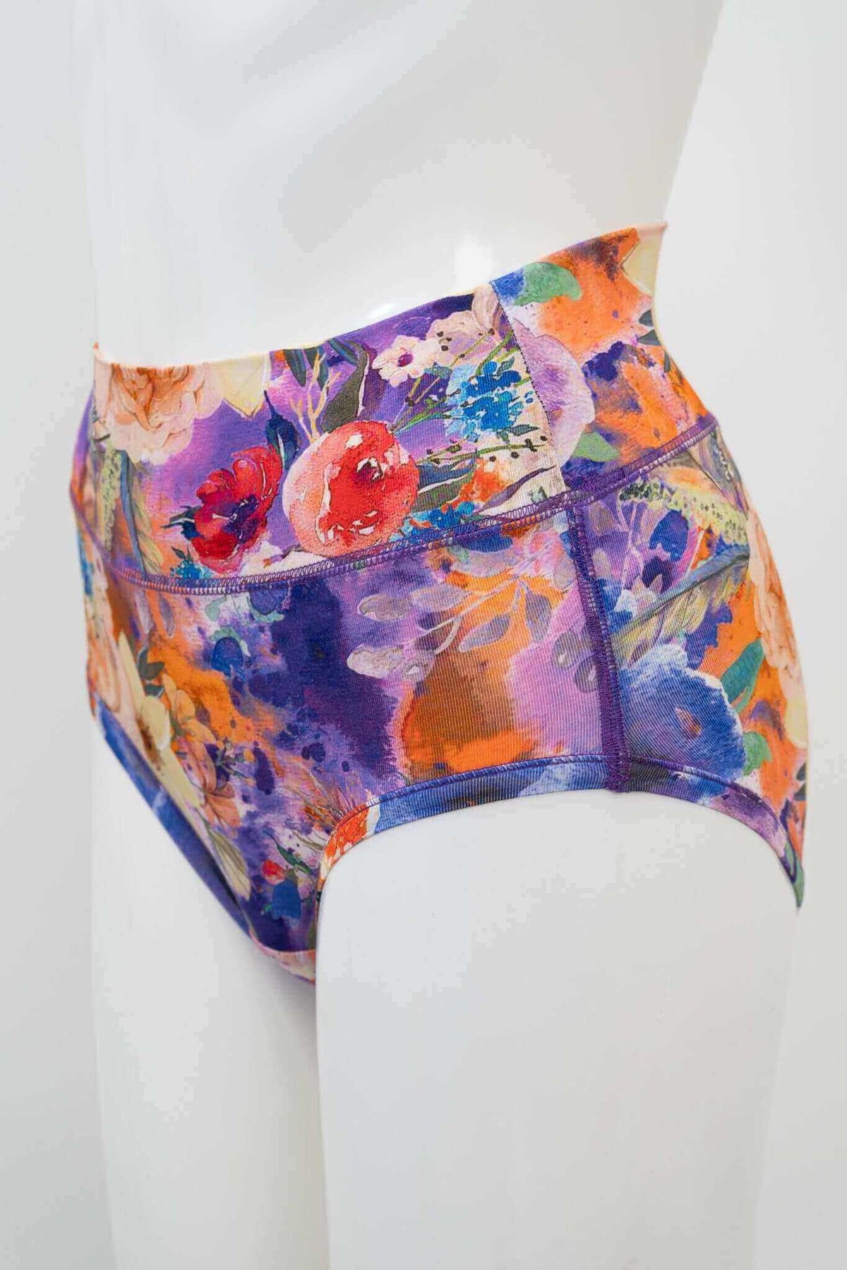 Side view of high-waist bamboo brief with colorful floral pattern on mannequin