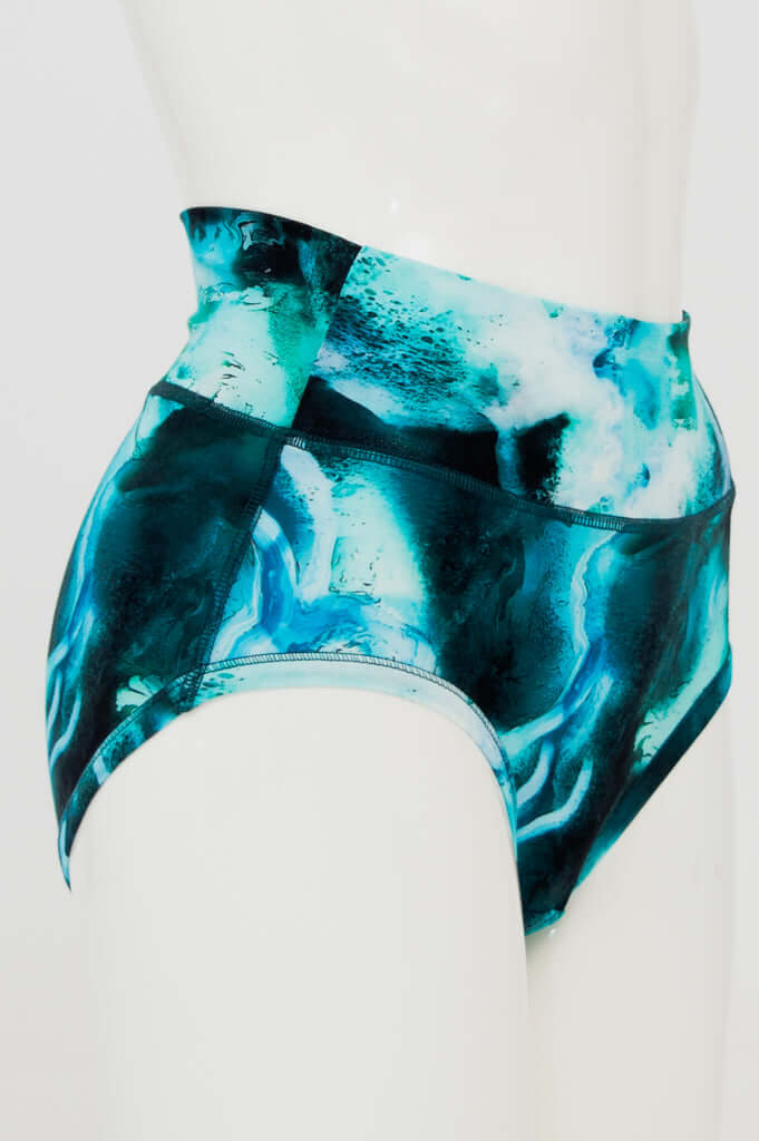 Side view of high-waisted brief with aqua marble design on mannequin