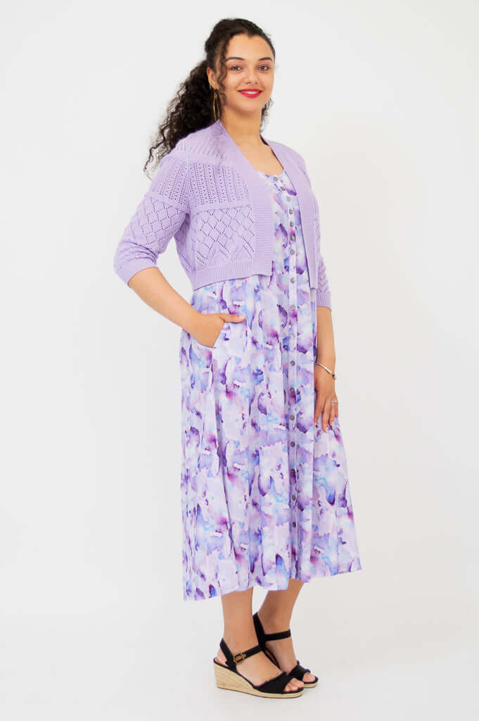 Side view of woman in lilac pointelle cropped cardigan and matching dress