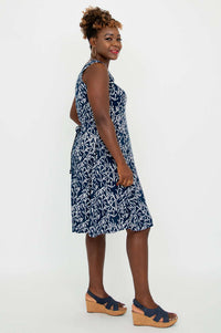 Side view of woman in navy and white patterned A-line summer dress