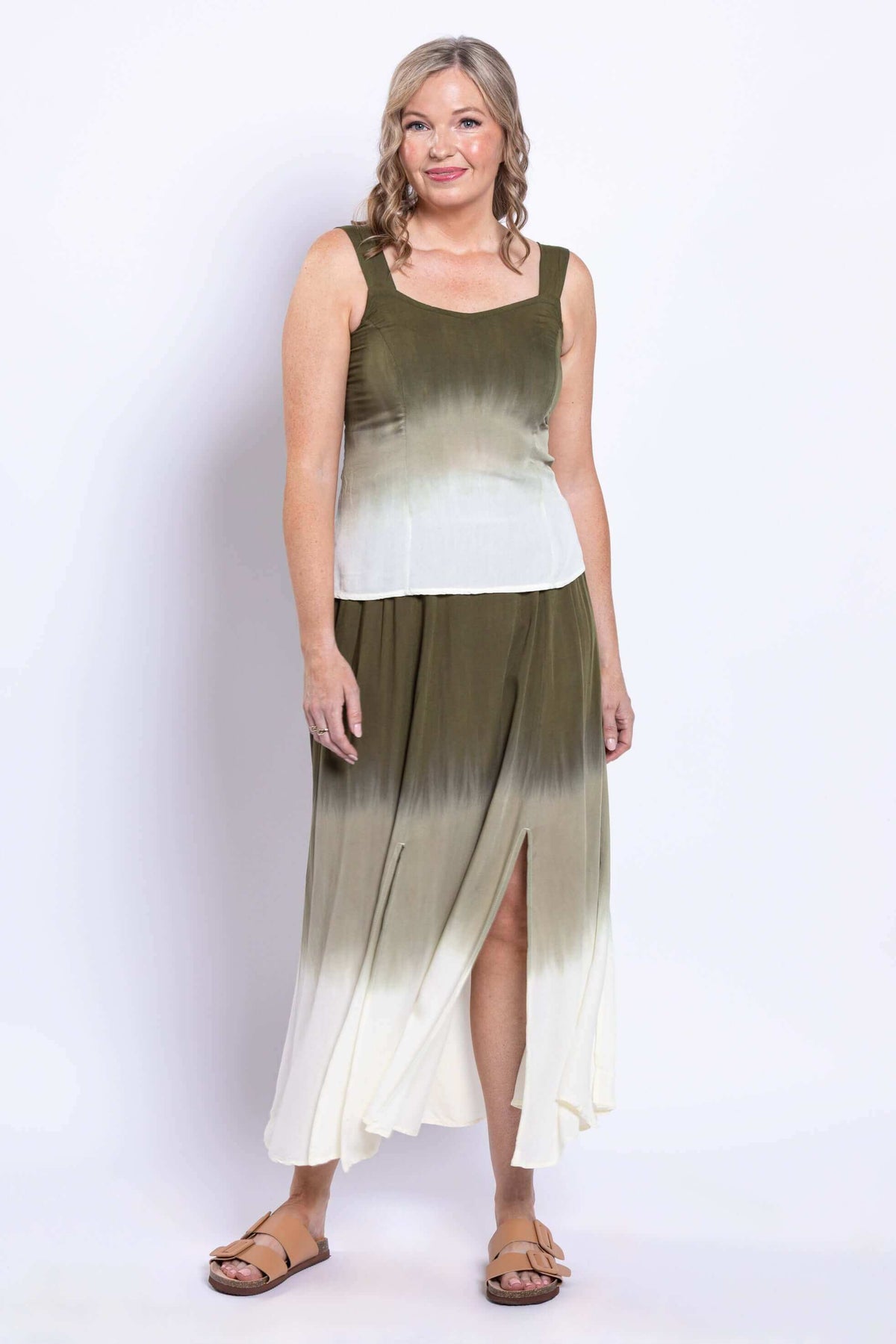 Side angle of a woman in an olive ombre skirt showing slits.