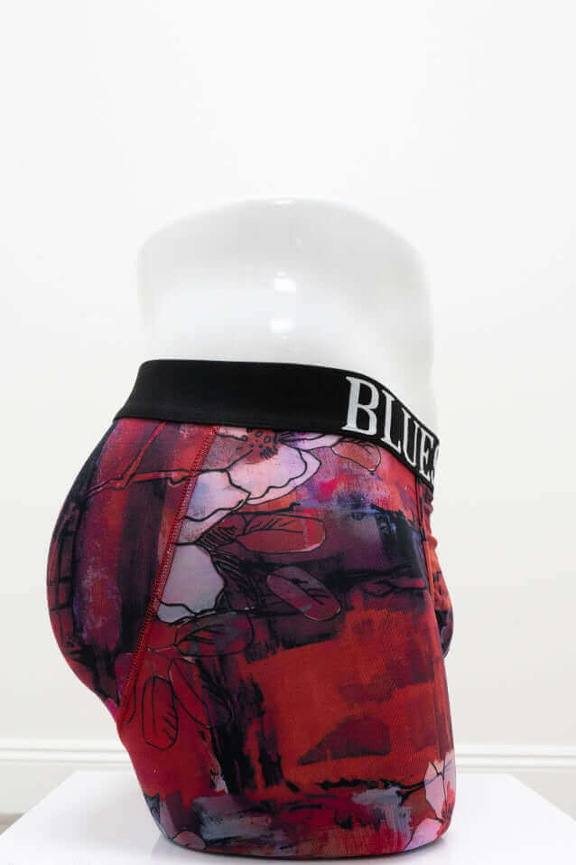 Side view of red floral bamboo men's underwear on mannequin showing waistband and fit