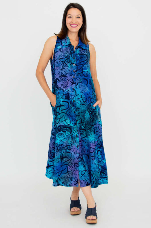 Woman wearing a sleeveless blue and purple A-line dress with collared neckline, facing forward