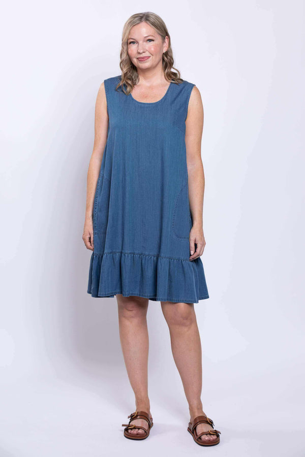 Model showing sleeveless blue dress with ruffle hem, facing forward