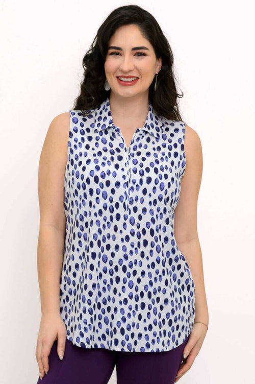 Woman wearing a sleeveless blue spotted quarter-zip tank top with a relaxed fit