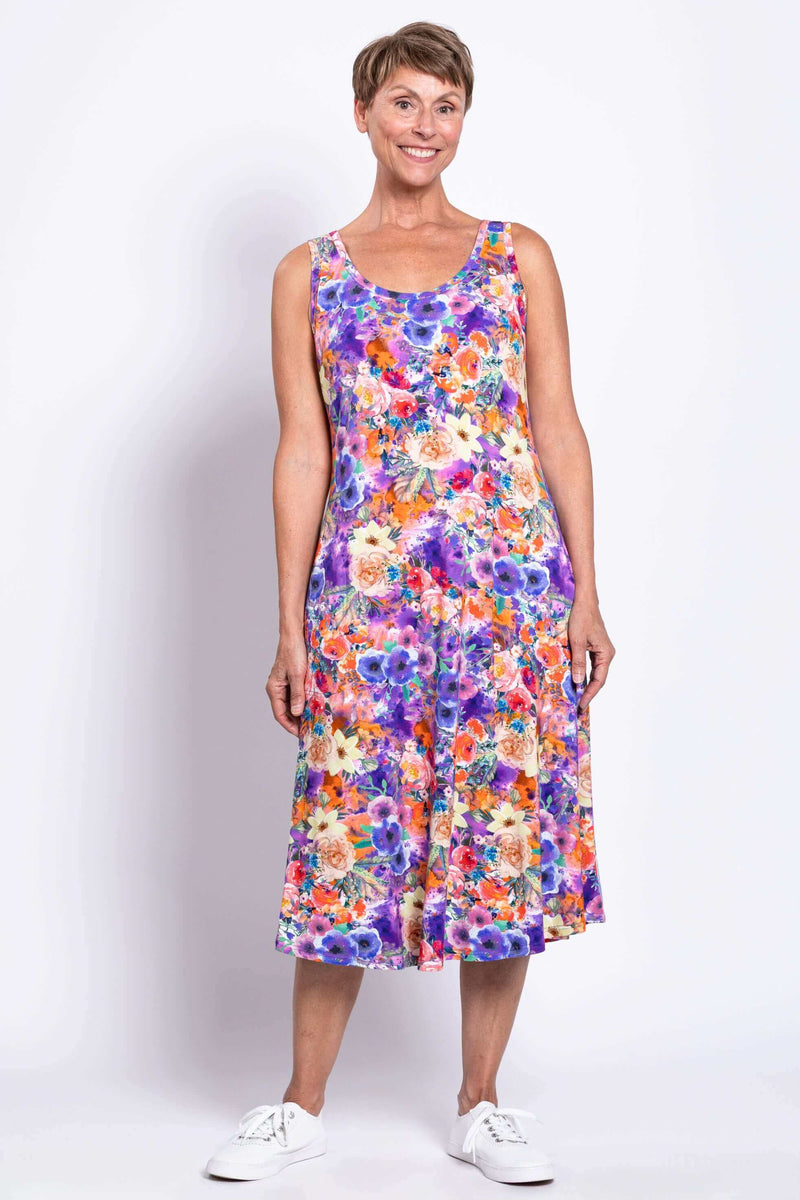 Woman wearing a sleeveless floral tank dress with a softly flared A-line silhouette, front view