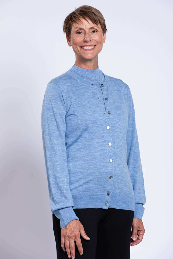 Smiling woman wearing a blue Merino wool cardigan, side view