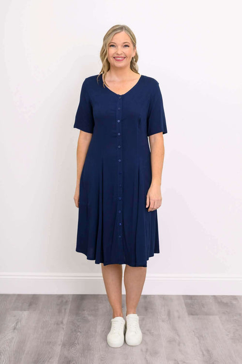 Smiling woman in navy blue knee-length button-front dress, front view