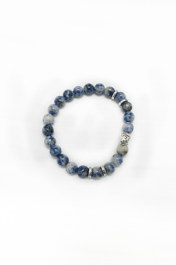 Sodalite bead bracelet with silver accents and Buddha charm on a white background