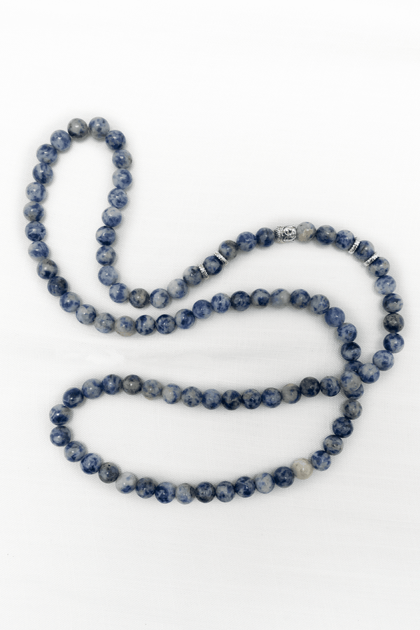 Sodalite mala necklace with blue beads and silver accents displayed on white background