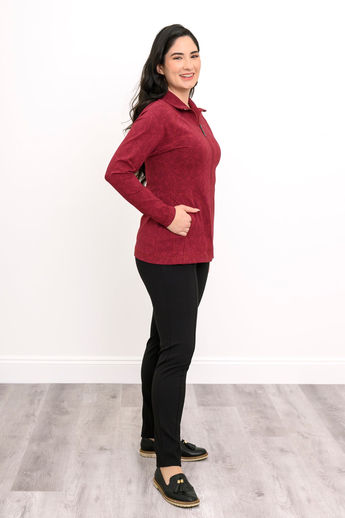 Slightly angled view of a women's red patterned mock neck jacket, showcasing a comfortable, body-skimming fit.