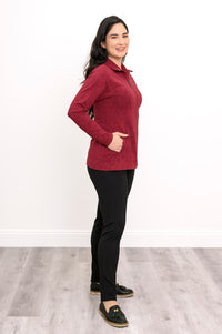 Slightly angled view of a women's red patterned mock neck jacket, showcasing a comfortable, body-skimming fit.