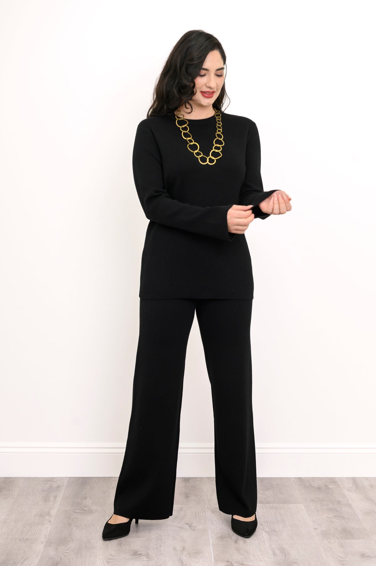 Front view of a women's ebony-colored rectangular knit top, showing a comfortable, loose-fitting drape.