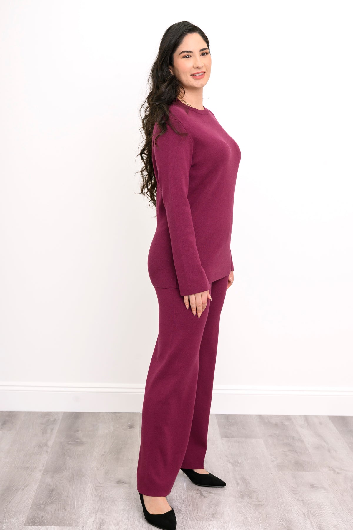 Side-facing view of a berry-pink crew neck sweater, highlighting the long tunic length and relaxed rectangular cut.