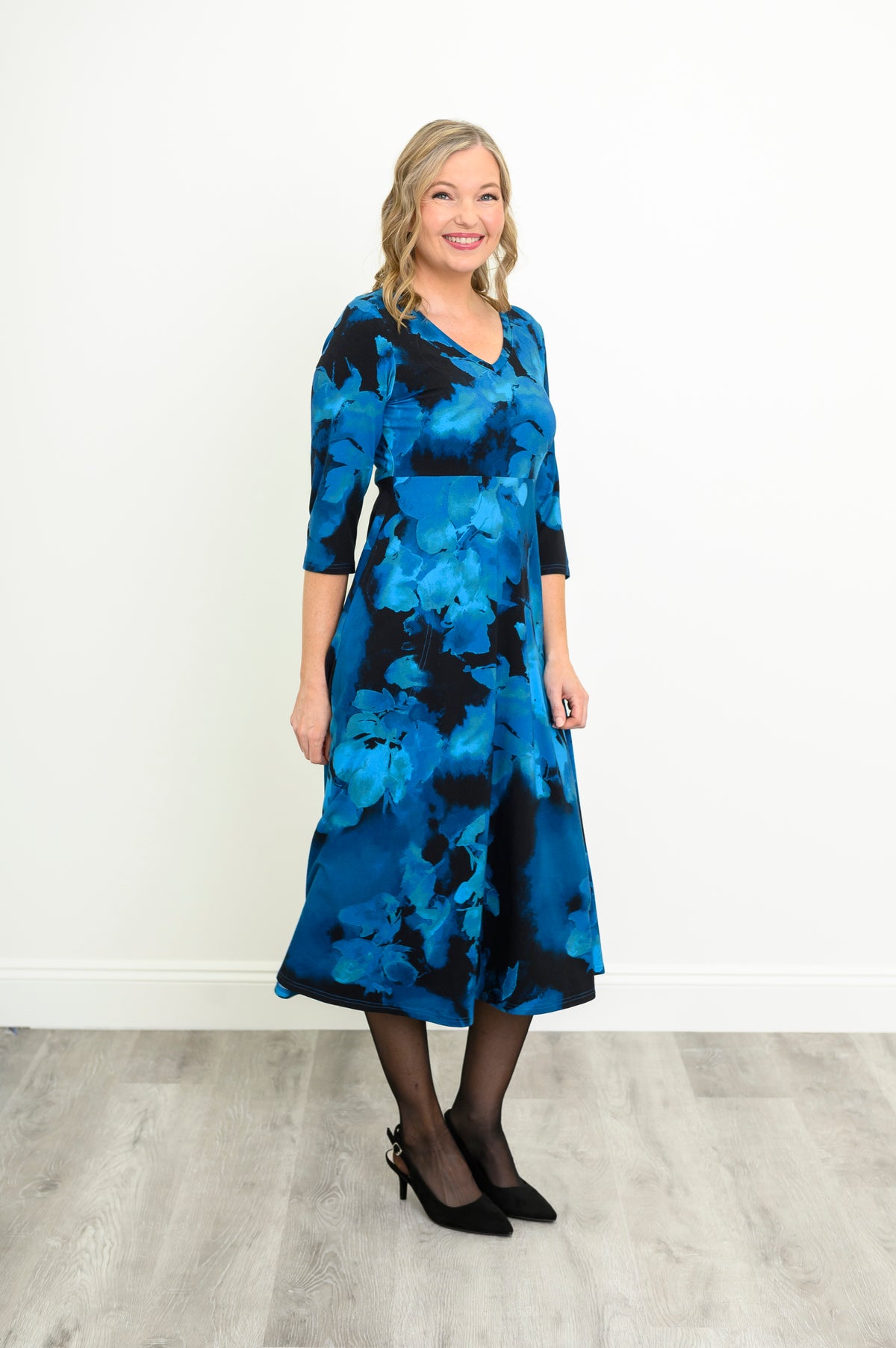 Flowy A-line midi dress in a dark blue abstract space print, shown from a front-facing angle.