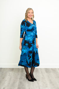 Flowy A-line midi dress in a dark blue abstract space print, shown from a front-facing angle.