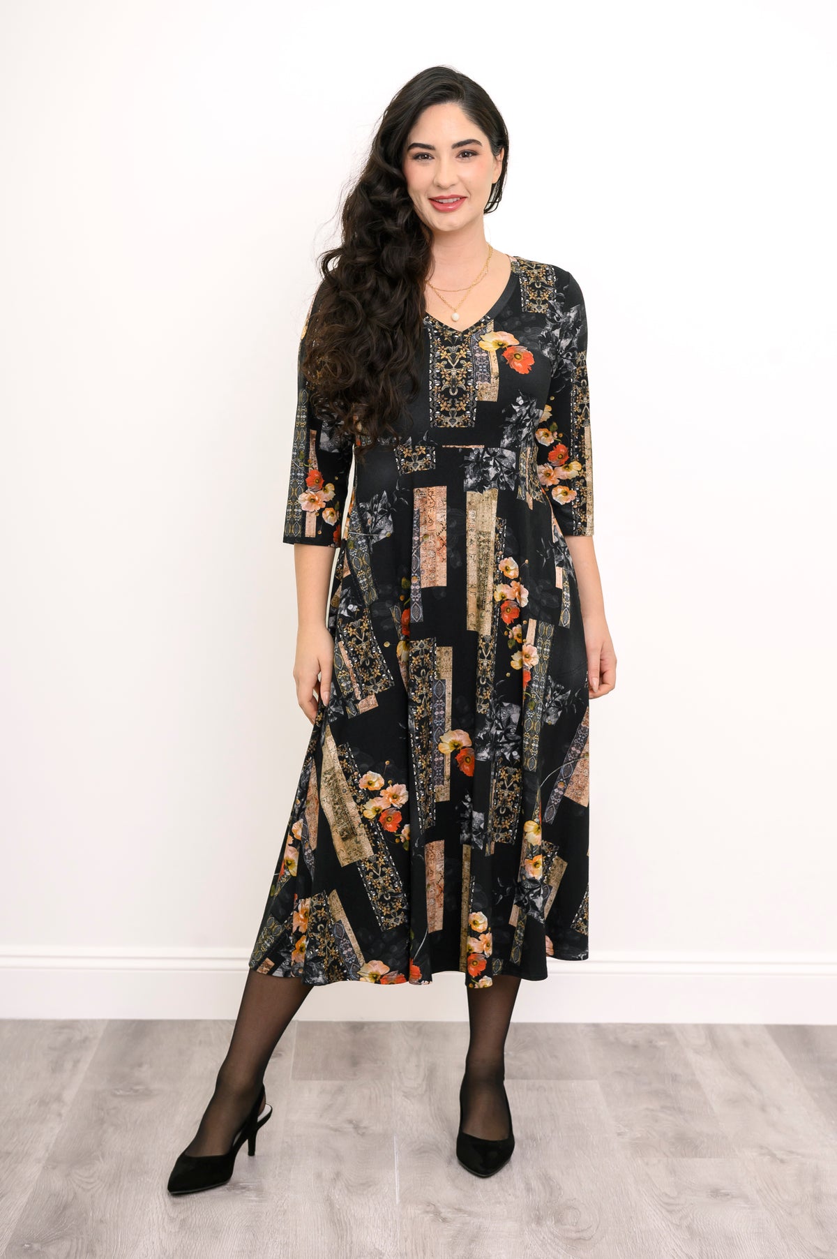 Front view of a women's black and orange floral bamboo midi dress, highlighting a relaxed, comfortable fit.