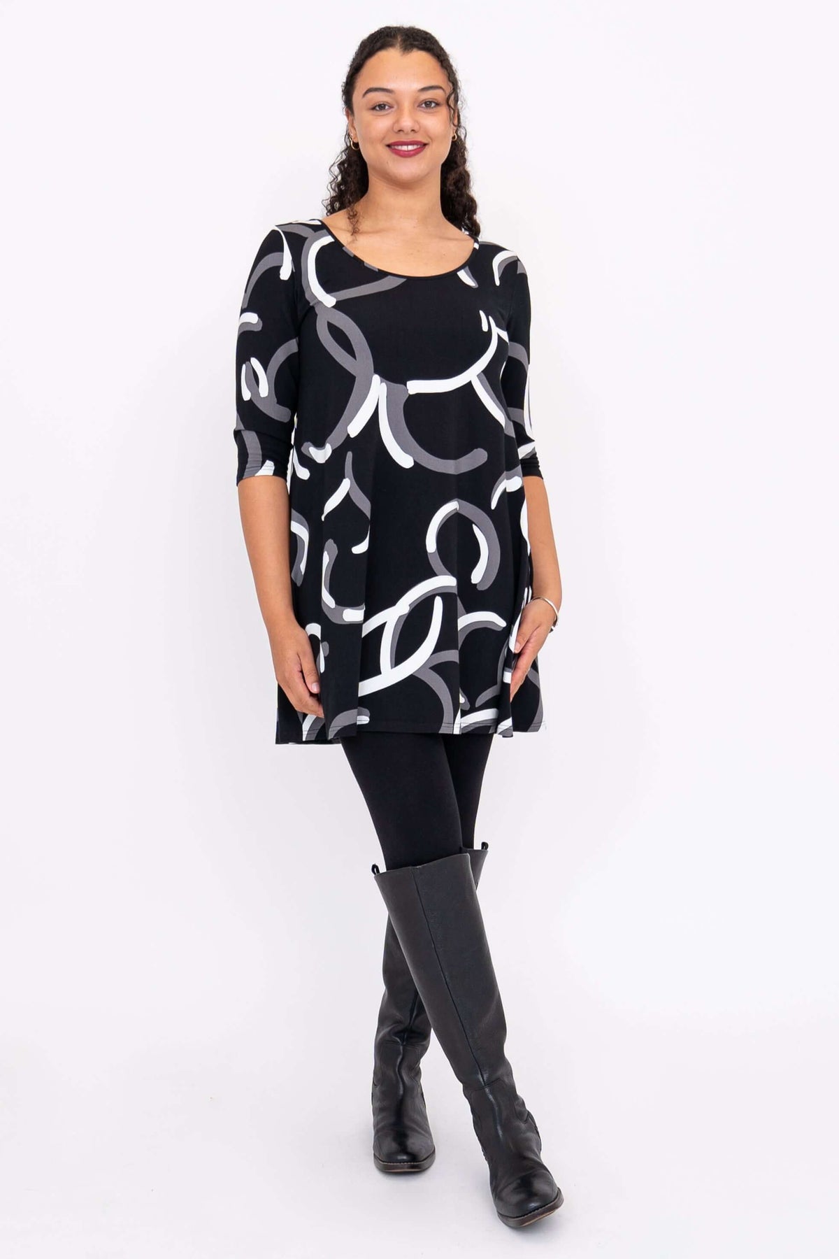 Spirit A-Line Dress shown from front, modeled with black leggings and boots, features scoop neckline