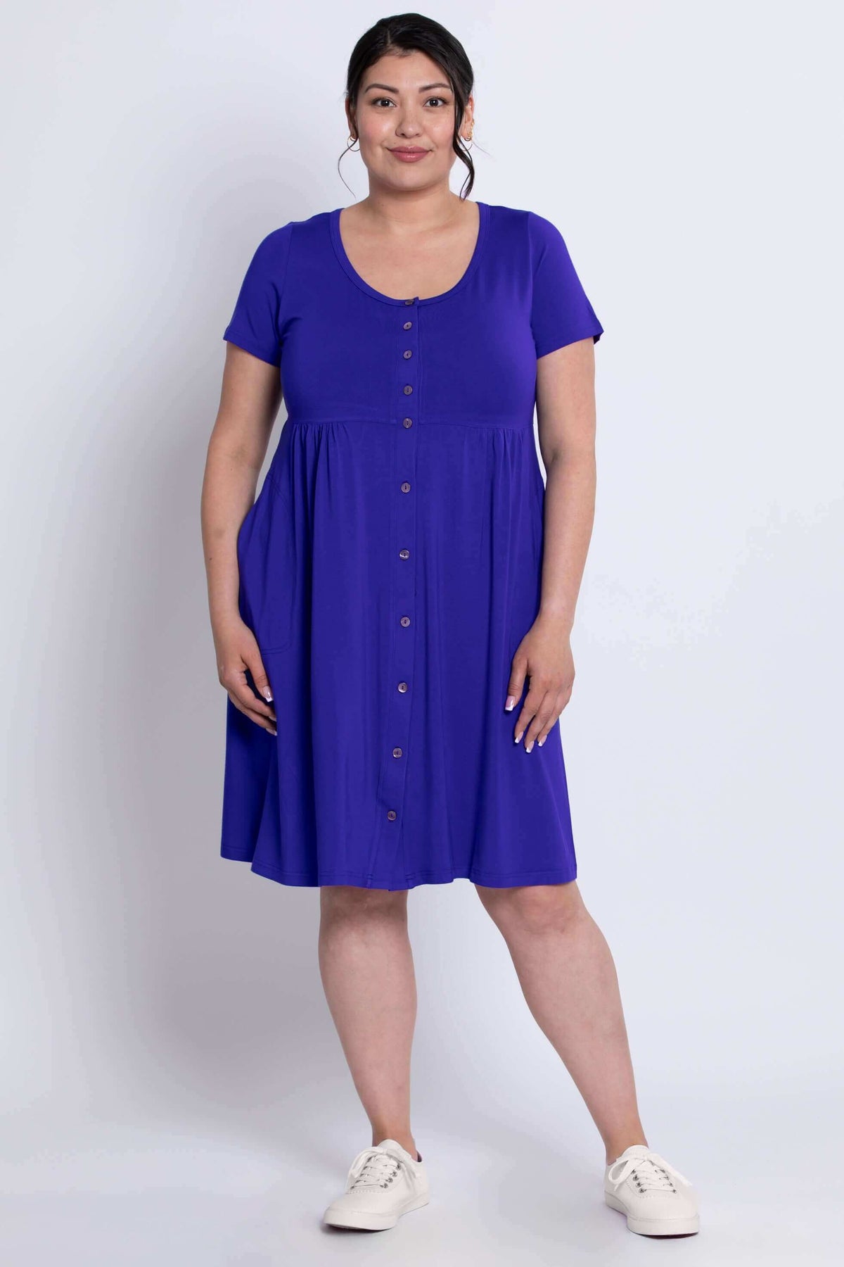 Woman wearing violet short sleeve bamboo dress, standing facing forward