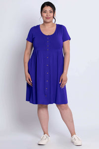 Woman wearing violet short sleeve bamboo dress, standing facing forward