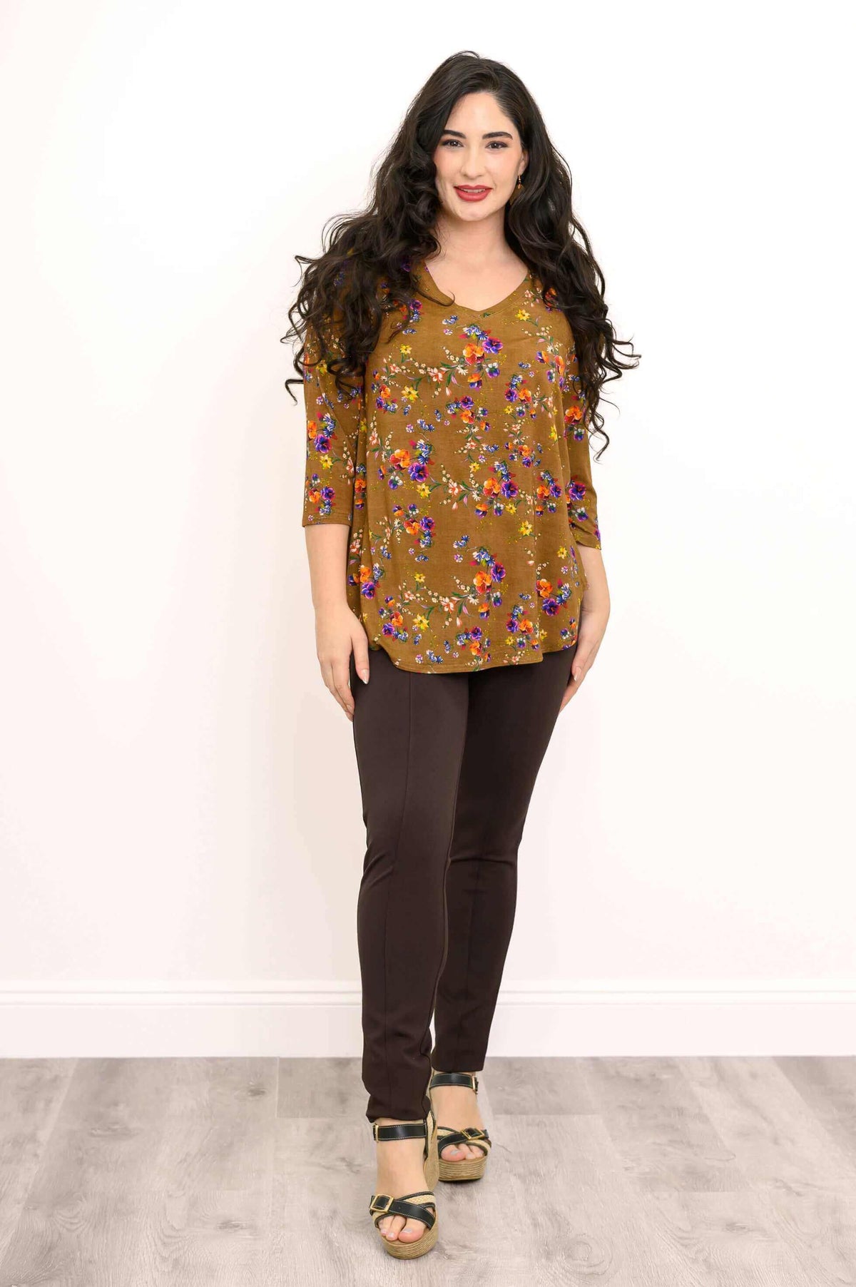 Woman standing straight in marigold floral V-neck bamboo top and platform sandals