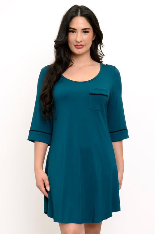 Woman wearing a teal nee-length nightgown with black trim