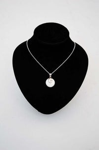Sterling silver Shiva Eye pendant necklace displayed on a black jewelry stand
