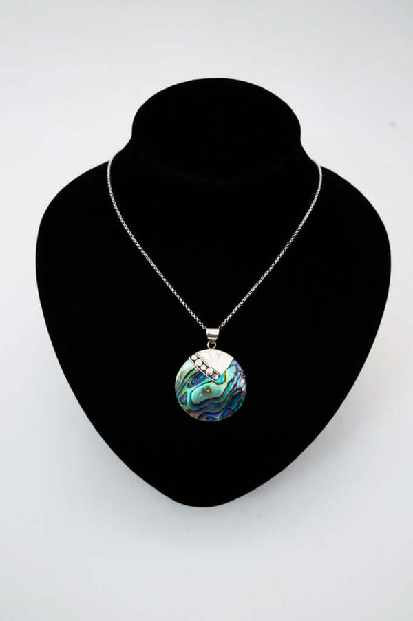 Sterling silver necklace with abalone pendant displayed on a black jewelry bust