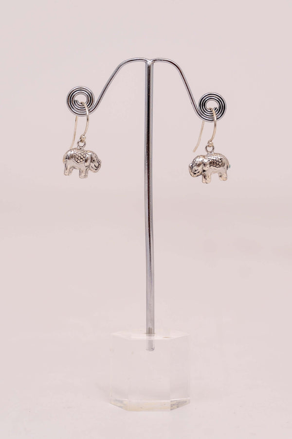 Pair of 925 sterling silver drop earrings with small elephant charms displayed on a stand