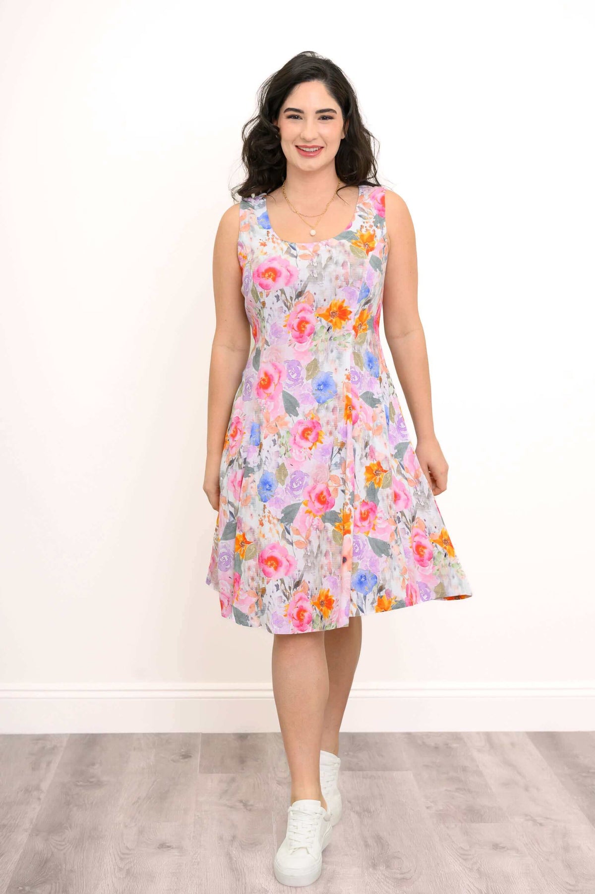 Woman standing front-facing in floral A-line dress with scoop neck