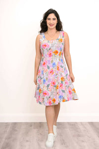 Woman standing front-facing in floral A-line dress with scoop neck