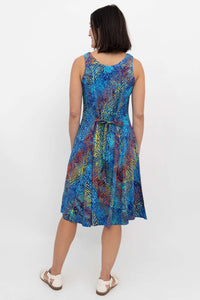 Back view of a woman in a sleeveless dress with electric palm print and tie belt