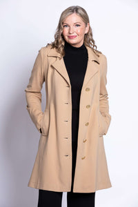 Woman wearing a tan modal trench jacket with button closure and notched collar