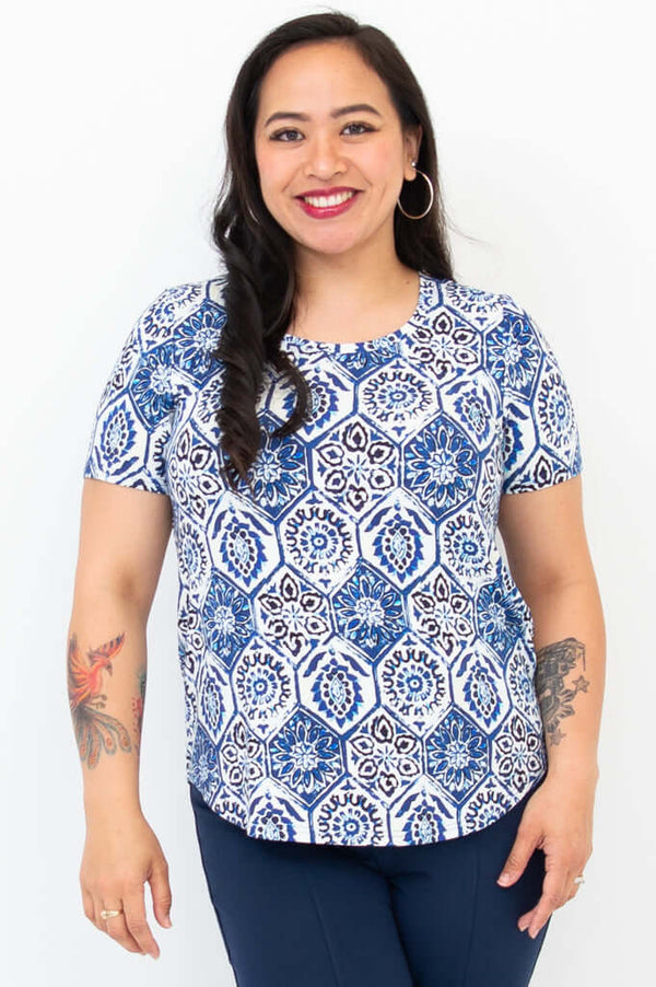 Front view of woman wearing Tessa Tee in blue mosaic print with short sleeves