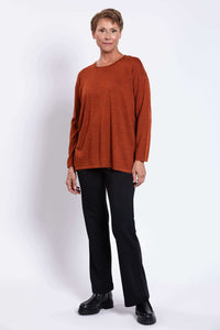 Three-quarter front view of a woman modeling a relaxed merino wool sweater