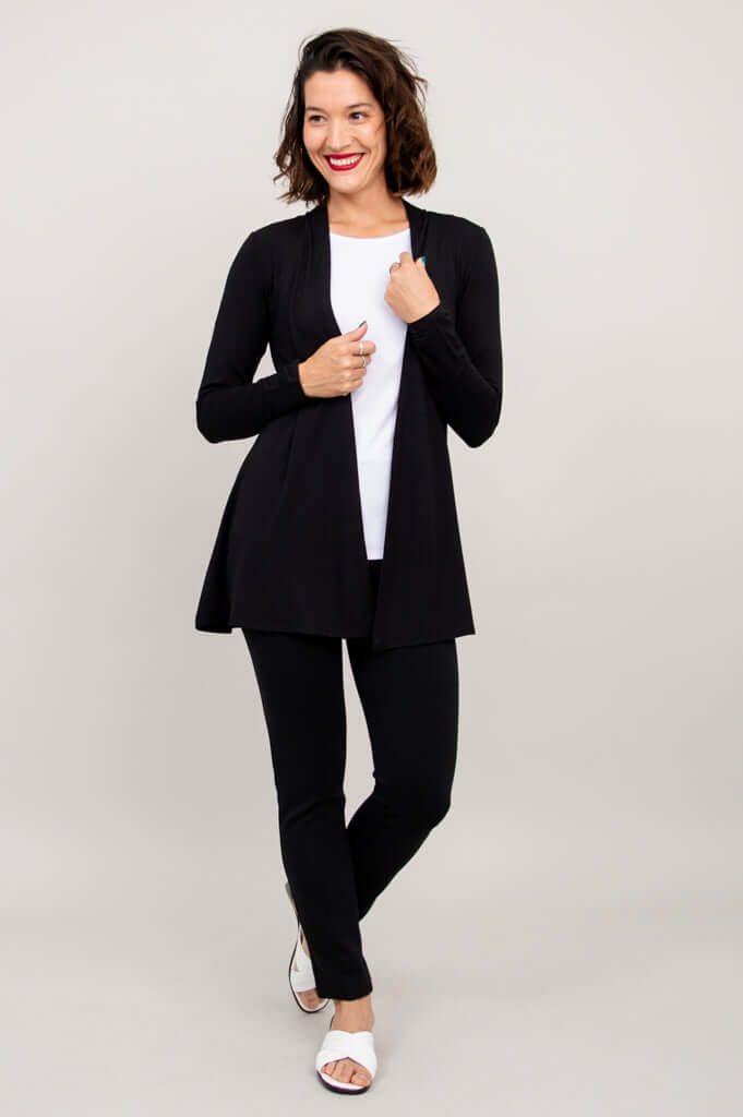 Three-quarter front view of model displaying black Chopra jacket in relaxed pose