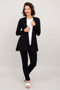 Three-quarter front view of model displaying black Chopra jacket in relaxed pose