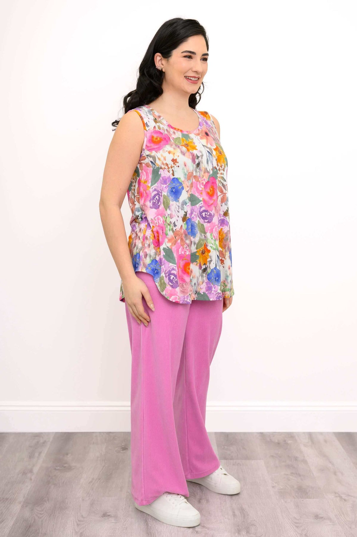 Three-quarter front view of the Jazz bamboo floral tank top with pink pants