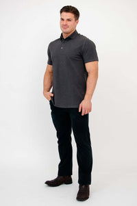Three-quarter front view of man modeling dark grey bamboo polo shirt