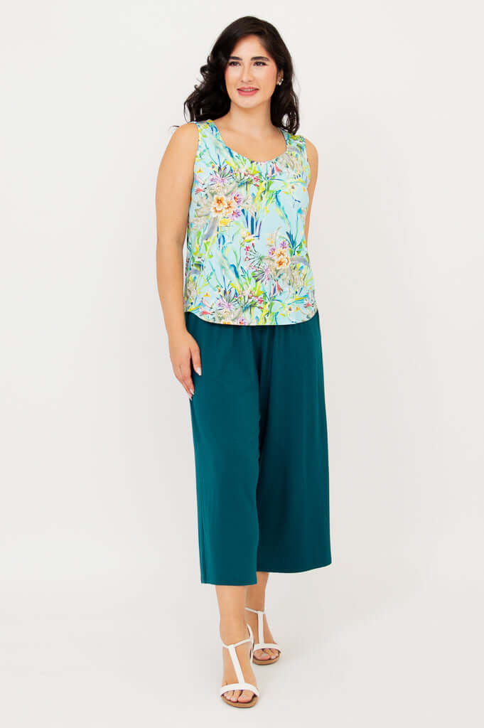 Three-quarter view of model showcasing Ritzy Tank floral top and teal pants
