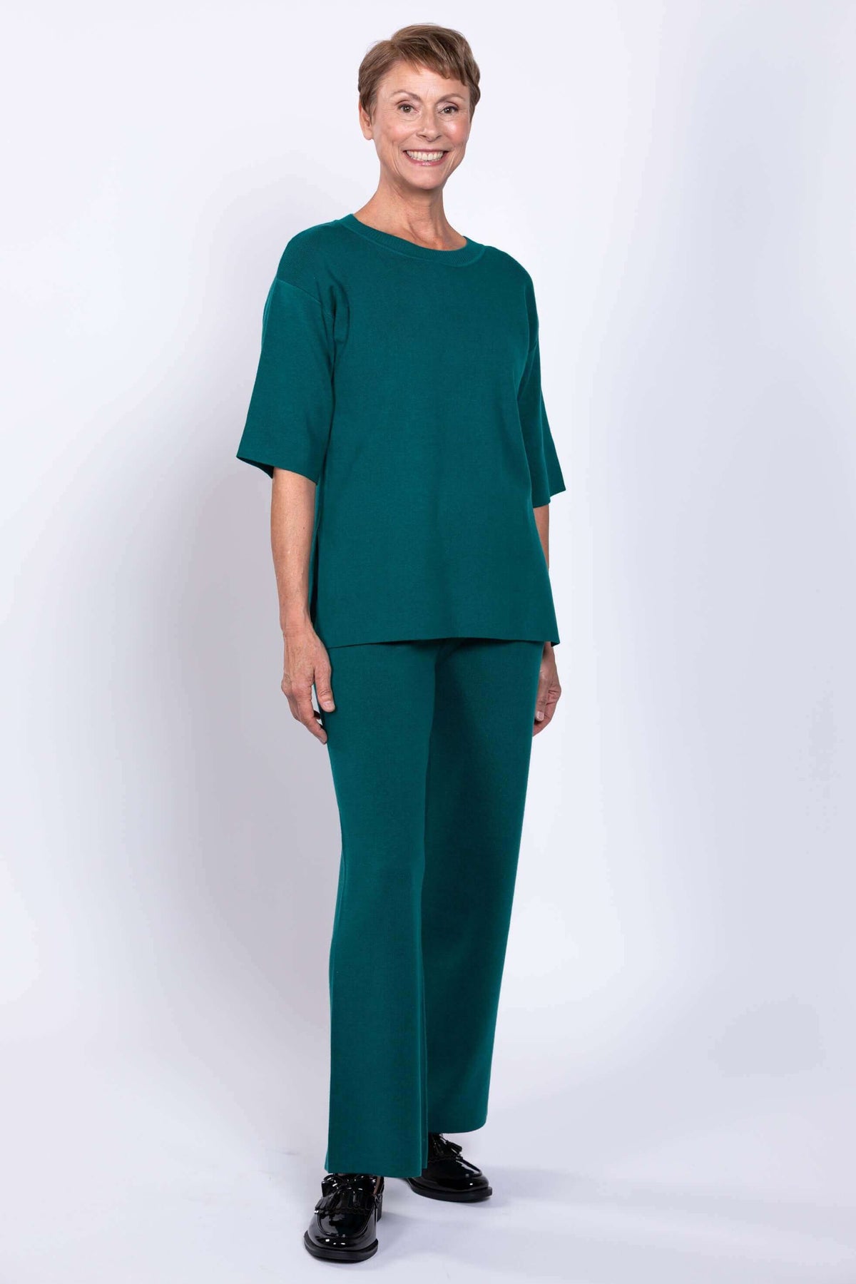 Three-quarter front view of model in teal Bailey Sweater and matching pants