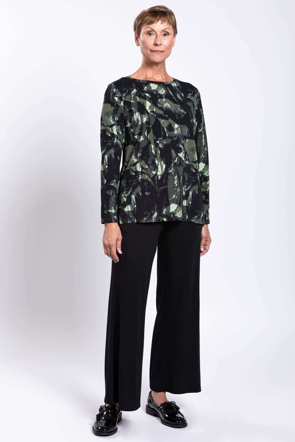 Three-quarter view of Margie printed boat neck top paired with black trousers