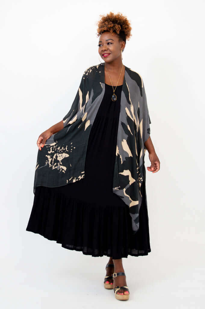 Three-quarters view of Darcy kimono wrap styled open over black maxi dress