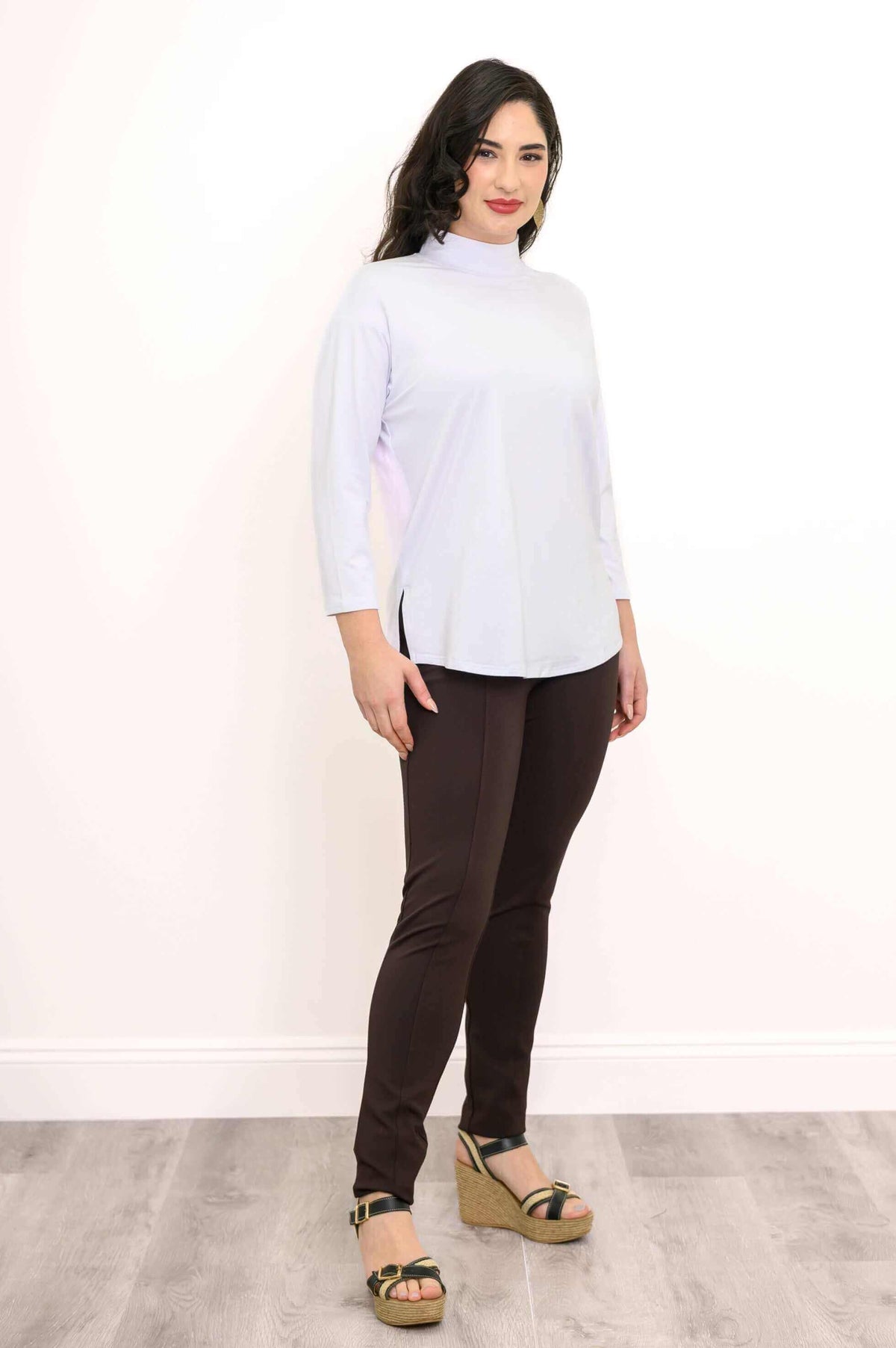 Three quarter front view of a woman in a white 3/4 sleeve bamboo top