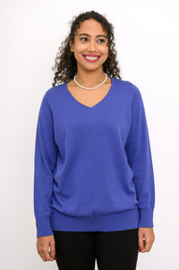 Hip length bright blue pullover sweater featuring a ribbed hem and cuffs for a comfortable casual outfit.