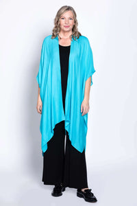 Woman facing forward in turquoise kimono-style wrap with relaxed fit