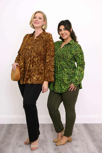 Two models in Cindy shirts, one in green leaf print and one in brown, standing side by side