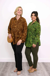 Two models in long sleeve smocked shirts, one in brown floral and one in green print