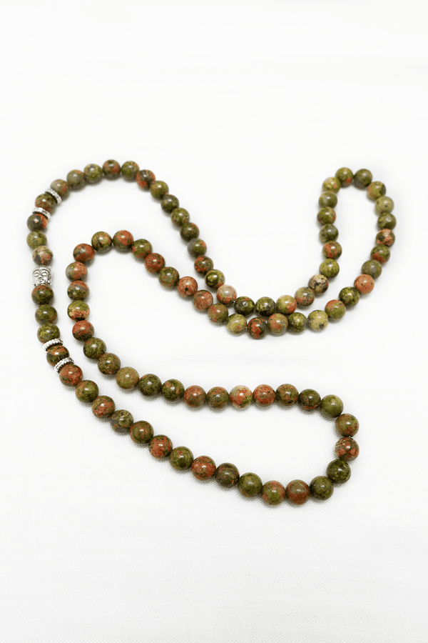 Unakite Jasper mala necklace with green and red beads on white background